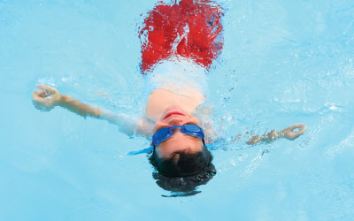 boy floating in pool